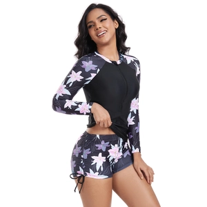 Close-up of long sleeve floral surf suit with front zipper and side drawstring detail
