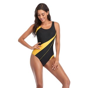 Close-up of sporty one-piece swimsuit with vibrant yellow dynamic stripes on black fabric