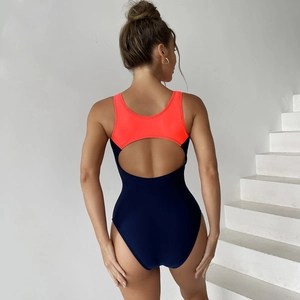 Rear view of sporty one-piece swimsuit with cutout back in neon orange and navy blue