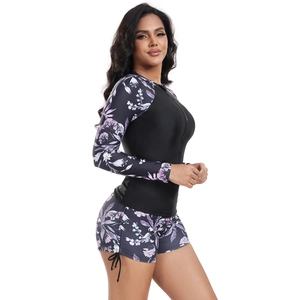 Detail view of long sleeve floral surf suit with zipper and side drawstring swim shorts