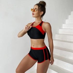 Detail of high-waist boy shorts and front zipper swim top in black and red sport bikini