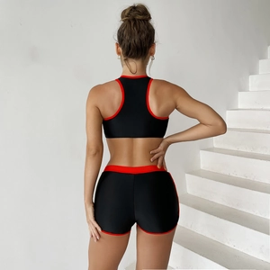 Rear view of sporty two-piece bikini with racerback top and high-waisted red trim shorts