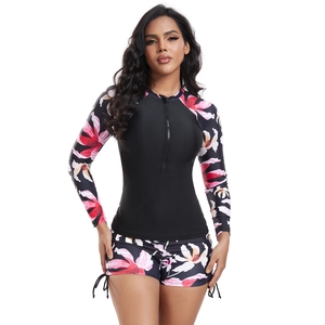 Detail of long sleeve floral surf suit with front zipper and side drawstring shorts