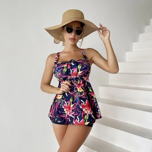 Detail of tropical floral print on a navy blue plus size tankini swimdress for women