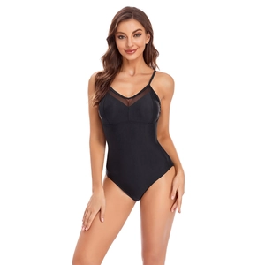 Detail of black one-piece swimsuit featuring mesh patchwork and thin shoulder straps