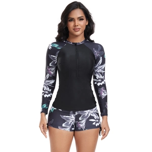Detail of long sleeve two-piece swimsuit with floral sleeves and front zipper closure