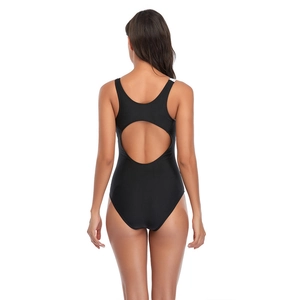 Detail of black one-piece swimsuit featuring a large circular back cutout and stretch fabric