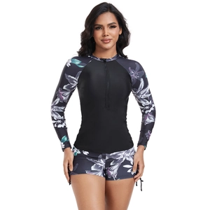 Close-up of long sleeve floral surf swimsuit set with front zipper and matching shorts