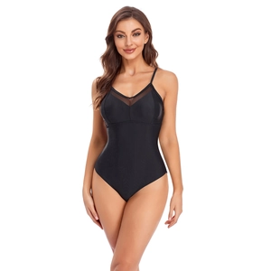 Close-up of black one-piece swimsuit with mesh paneling and skinny shoulder straps