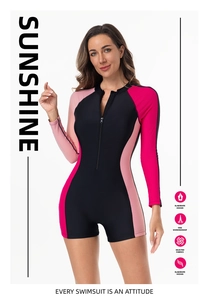 Close-up of long sleeve one piece swimsuit with pink color blocks and front zipper detail