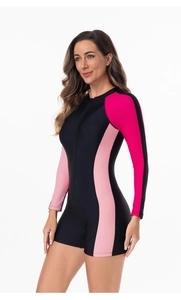 Close-up of long sleeve one-piece surfing swimsuit with front zipper and pink side panels