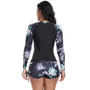 Back view of women's long sleeve surf bikini set with purple floral print and drawstring shorts
