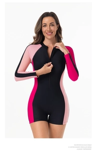 Front view of long sleeve one-piece swimsuit with black and pink color block detailing