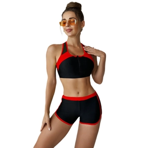 Women's black two-piece sporty bikini set with red trim and front zipper top