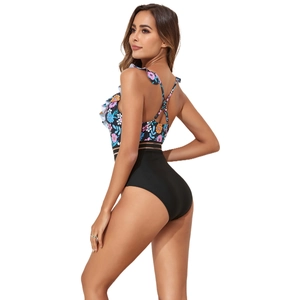 Detail of cross back straps and floral ruffle trim on this stylish one piece swimsuit