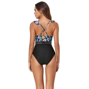 Detail of cross-back straps and floral print on a black mesh-spliced one-piece swimsuit