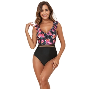 Detail of V-neck ruffle trim and tropical floral print on a one-piece swimsuit