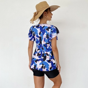 Detail view of floral print tankini top with ruffled sleeves and black swim shorts