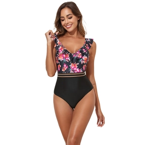 Detail of V-neck one-piece swimsuit with floral print, ruffles and gold striped waist band