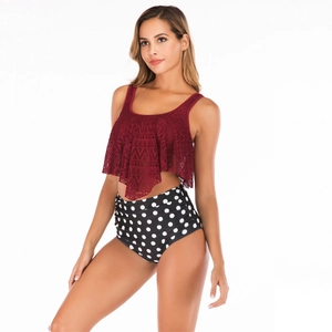 Detail of burgundy lace bikini top with ruffles and high-waisted black polka dot bottoms