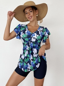 Detail of floral printed tankini top with drawstring chest and black swim shorts