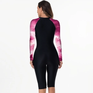 Rear view of long sleeve surfing swimsuit with pink marble print sleeves and black body