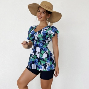 Detail of floral tankini top with V-neck drawstring and blue boy shorts swim bottom