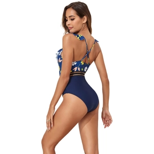 Detail of one-piece swimsuit featuring floral print, ruffled straps, and cutout waistline