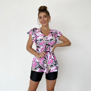 Close-up of V-neck tankini top with pink abstract patterns and ruffled sleeve details