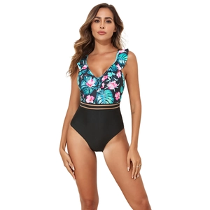 Detail of V-neck one-piece swimsuit with tropical floral print and mesh waist cutouts