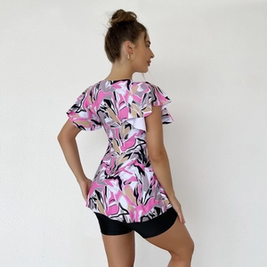 Detail view of floral print tankini top with ruffle sleeves and abstract pattern back