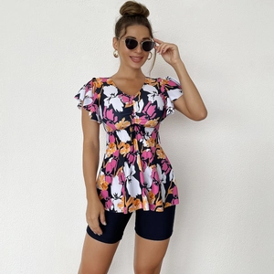 Close-up of a floral tankini top with ruffle sleeves and adjustable drawstring waist detail
