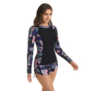 Detail of long sleeve surfboard swimsuit with tropical print and side drawstring shorts