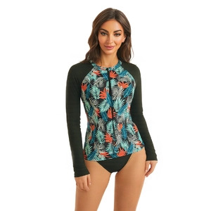 Detail of long-sleeve floral surfboard swimsuit with front zipper and athletic bikini cut