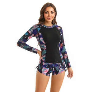 Detail of long sleeve surfboard swimwear with tropical palm print and side drawstring shorts