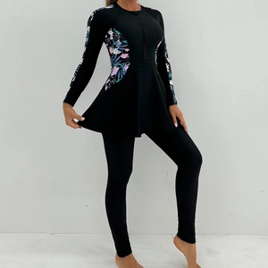 Close-up of long sleeve modest swimwear with tropical floral print and front zipper detail