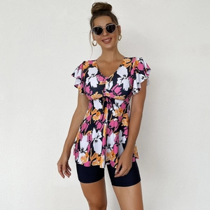 Detail of floral V-neck tankini top with drawstring and ruffled sleeves with swim shorts