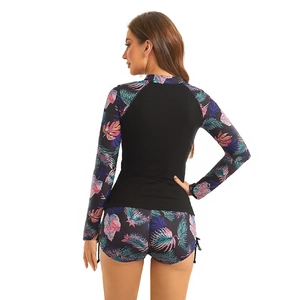 Detail of long sleeve surfboard swimwear set with tropical leaf patterns and side drawstrings