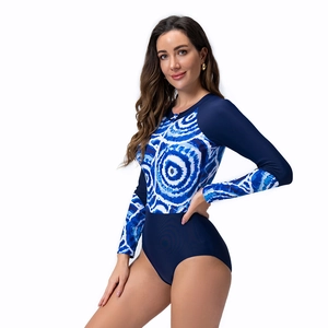 Close-up of long sleeve swimsuit featuring blue tie-dye patterns and front zipper detail