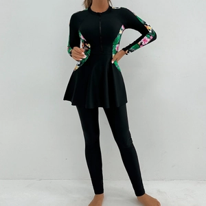 Detail of modest long-sleeve swimwear with tropical floral print and front zipper closure