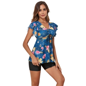Detail of floral V-neck swim top with ruffle sleeves and black tankini bottoms