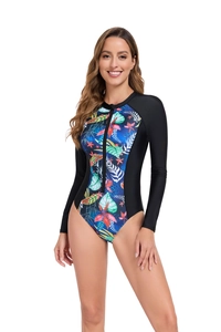 Close-up of long sleeve swimsuit featuring tropical floral prints and front zipper detail