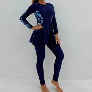 Detail of modest long-sleeve swimwear with tropical leaf print and side zipper closure