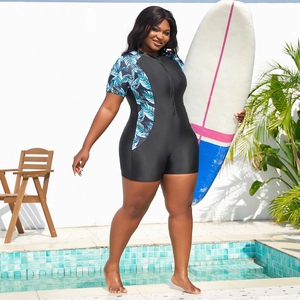 Detail of short sleeve one-piece surfing suit with tropical leaf print and front zipper