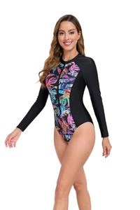 Close-up of tropical palm leaf print and black front zipper on women's long sleeve swimsuit