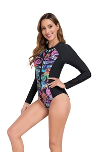 Close-up of long sleeve swimsuit featuring tropical leaf prints and front zipper detail