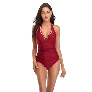 Detail of dark red one-piece swimsuit featuring a V-neckline and elegant waist ruching