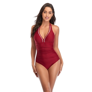 Detail of burgundy one-piece swimsuit with plunging V-neckline and ruched waist design