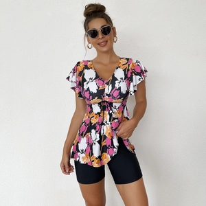 Two-piece tankini set featuring floral top with ruffle sleeves and high waist black shorts
