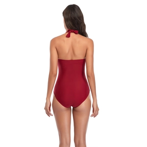 Back view of deep red halter one-piece swimsuit with elegant bow tie detail